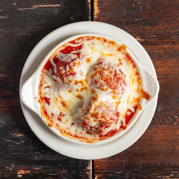 Bambino's Urban Pizzeria's baked meatballs covered in marinara sauce and melted mozzarella cheese.