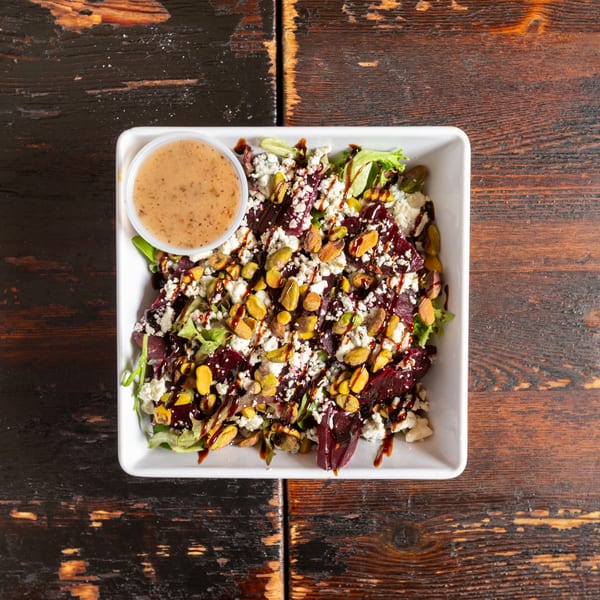 Bambino's Urban Pizzeria's beet and pistachio salad with feta cheese and balsamic glaze.