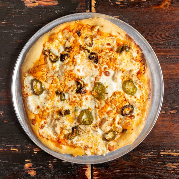 Bambino's Urban Pizzeria's chicken and jalapeño pizza, with melted cheese and a golden crust.